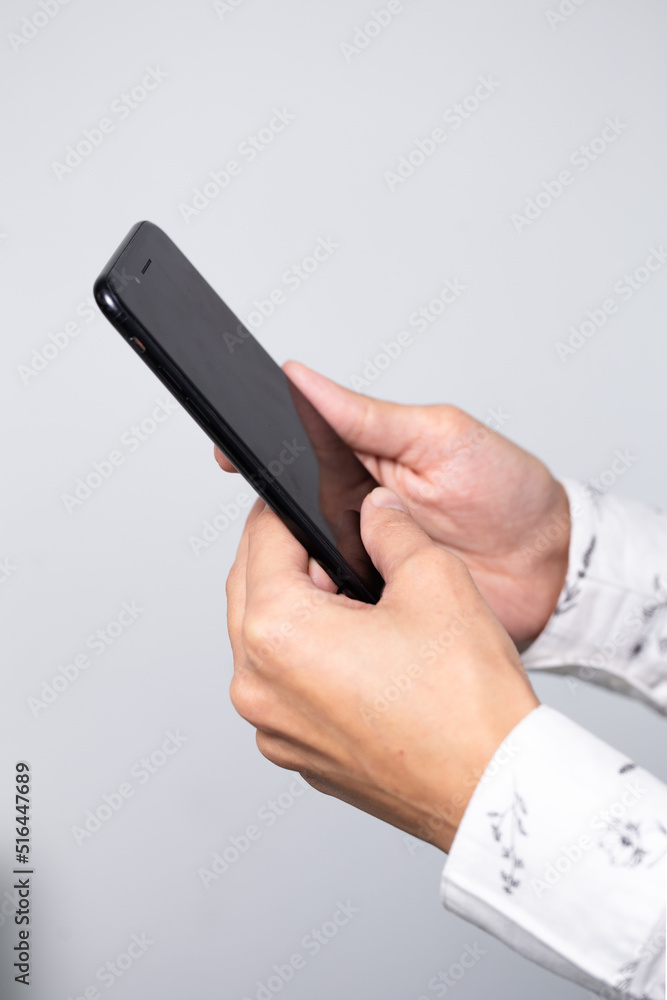 black smartphone in men's hands close-up on a white background black smartphone in men's hands close-up on a white background
