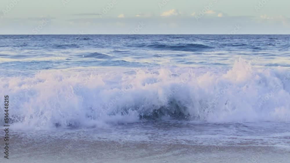 Majestic lilac sunset reflecting in shining waves. Slow motion splashing pink waves rolling to Hawaii island beach. Dramatic blue ocean waves in gentle pastel colors, nature background for copy space Majestic lilac sunset reflecting in shining waves. Slow motion splashing pink waves rolling to Hawaii island beach. Dramatic blue ocean waves in gentle pastel colors, nature background for copy space