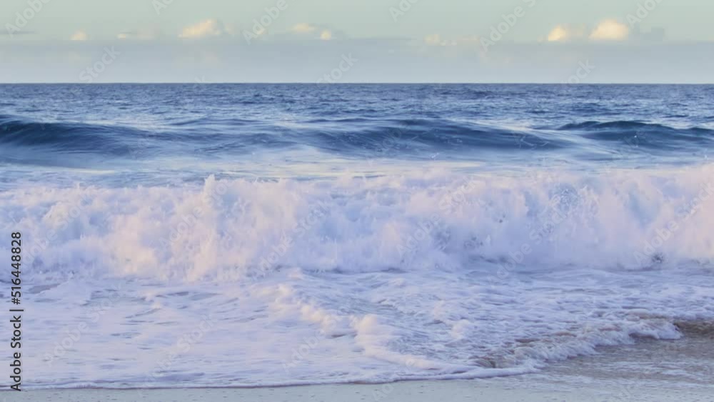Slow motion splashing pink waves rolling to beach on Hawaii island. Dramatic blue ocean waves in gentle pastel colors, nature background for copy space. Majestic sun light reflecting in shining waves Slow motion splashing pink waves rolling to beach on Hawaii island. Dramatic blue ocean waves in gentle pastel colors, nature background for copy space. Majestic sun light reflecting in shining waves