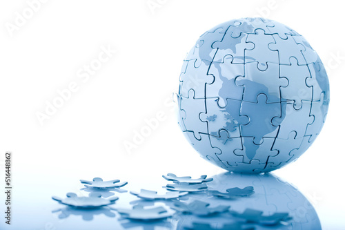 Metallic Globe Jigsaw Puzzle with Pieces Around on White Background