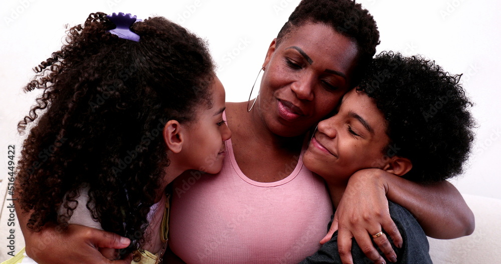 African mother embracing son and daughter. Mixed race mom hugging children African mother embracing son and daughter. Mixed race mom hugging children