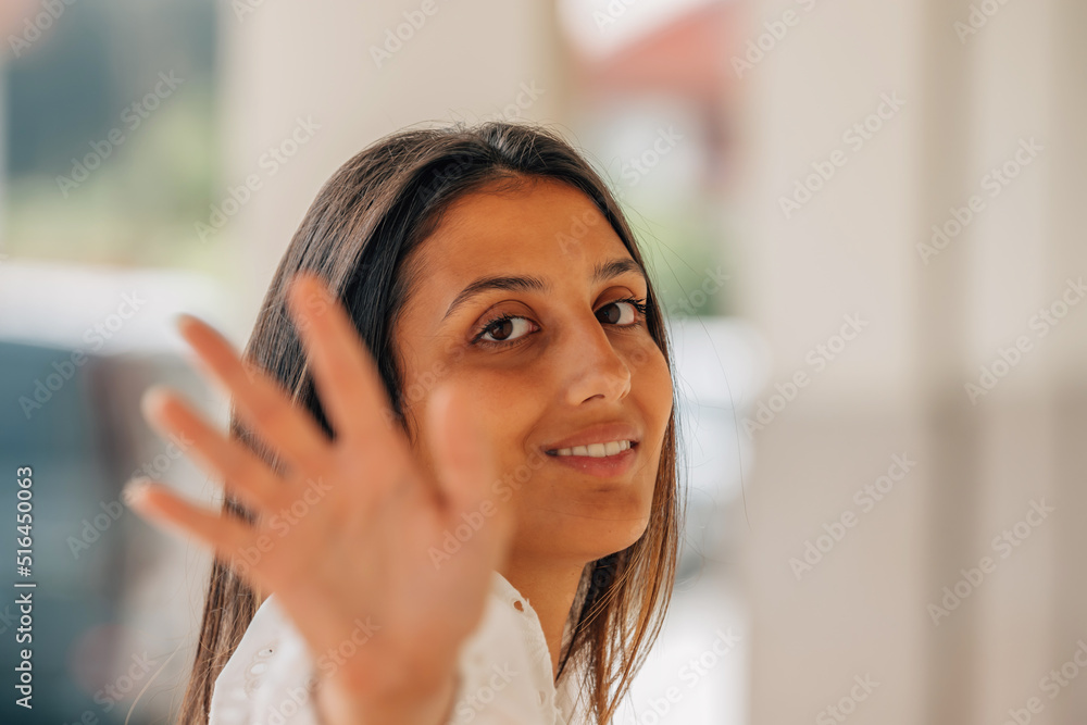 latin american girl in the street smiling with hand latin american girl in the street smiling with hand