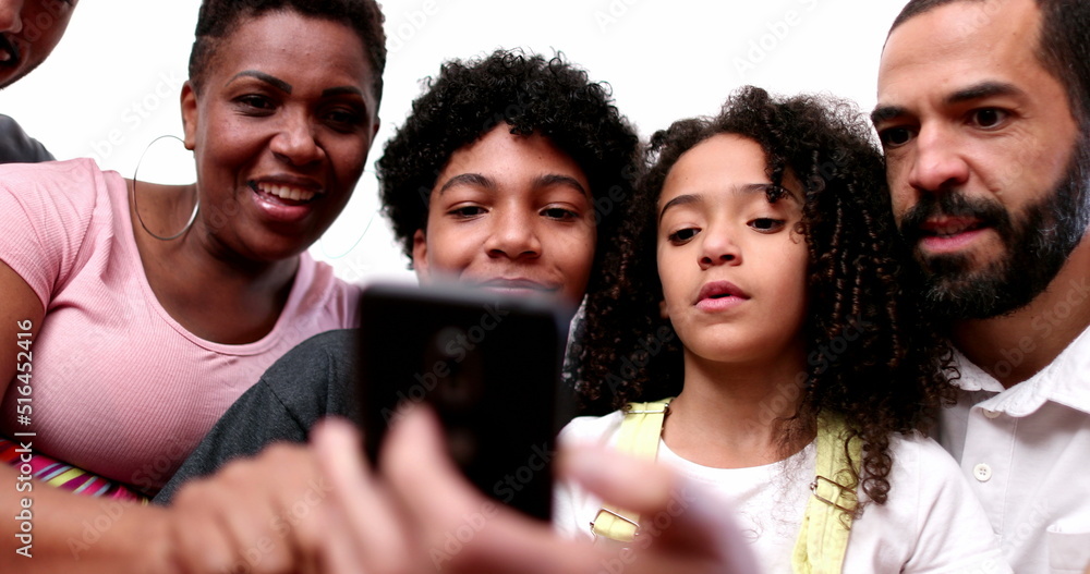 Fototapeta premium African descent family looking at cellphone together