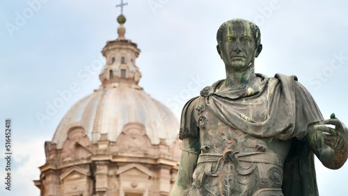 Statue of Julius Caesaer located in the centre of Rome, Italy. Buildings on the background photo