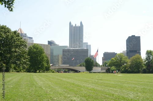 Green lawn surrounded by trees the backdrop of the One PPG Place skyscraper in Pittsburgh.USA
