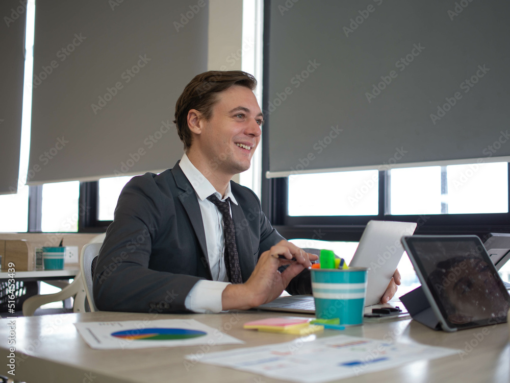 Businessman manager young adult person siting work job conference customer financial marketing eduction study learn class happy enjoy smile.Male play tablet notebook computer technology indoor company Businessman manager young adult person siting work job conference customer financial marketing eduction study learn class happy enjoy smile.Male play tablet notebook computer technology indoor company