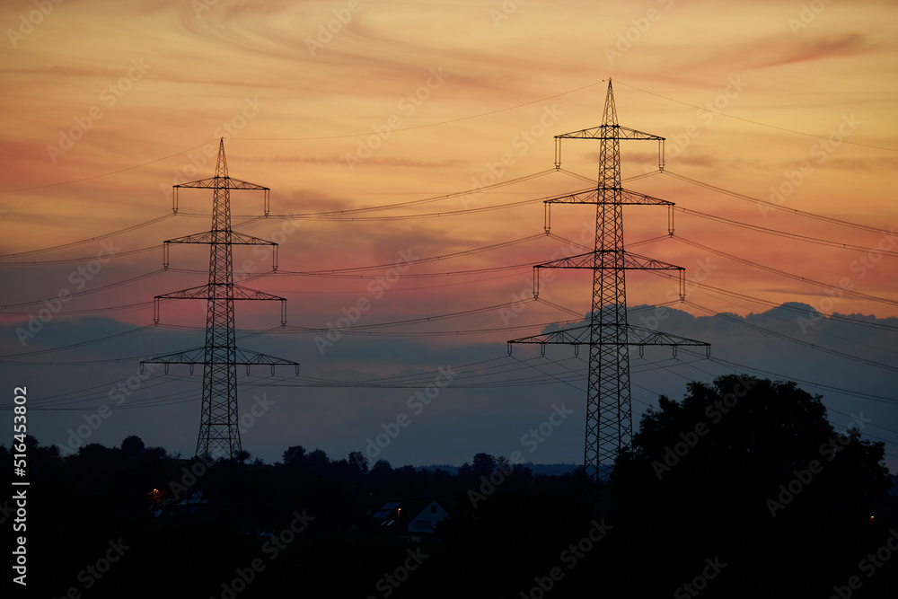 2 power pylons before sunset. Energy crisis in Europe because high electricity prices. Germany, Nurtingen.