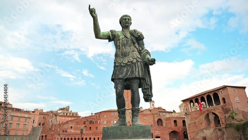 Statue of Augustus Caesar with ancient buildings on the background in Rome, Italy photo