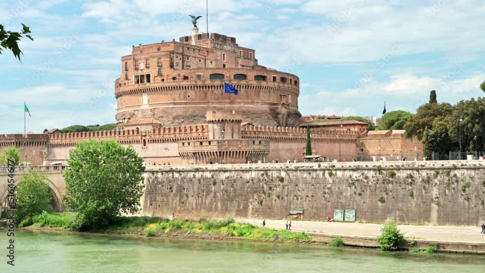 View of the Tiber River and Castle of the Holy Angel in the center of Rome, Italy. Embankment street with people View of the Tiber River and Castle of the Holy Angel in the center of Rome, Italy. Embankment street with people