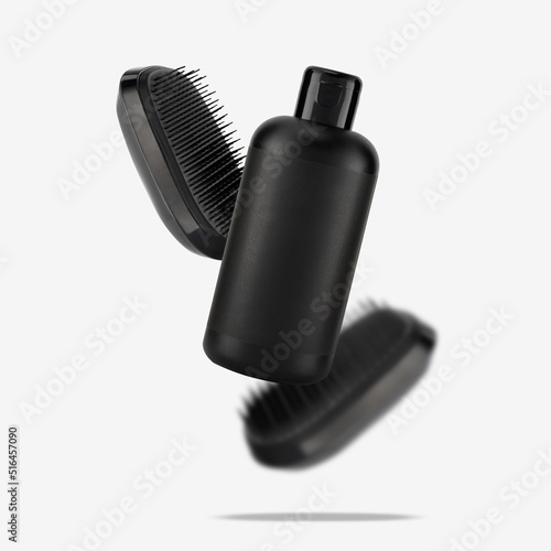 Two detangler hair brushes and bottle of shampoo float on white. Conceptual photo of accessories for the care and health of the head skin and hair. Creative modern image on a light gray background photo