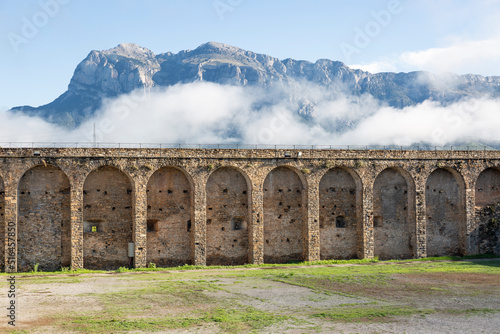 arcades of the castle wall with a view to the mountain at Aínsa (Aínsa-Sobrarbe), Sobrarbe, province of Huesca, Aragon, Spain