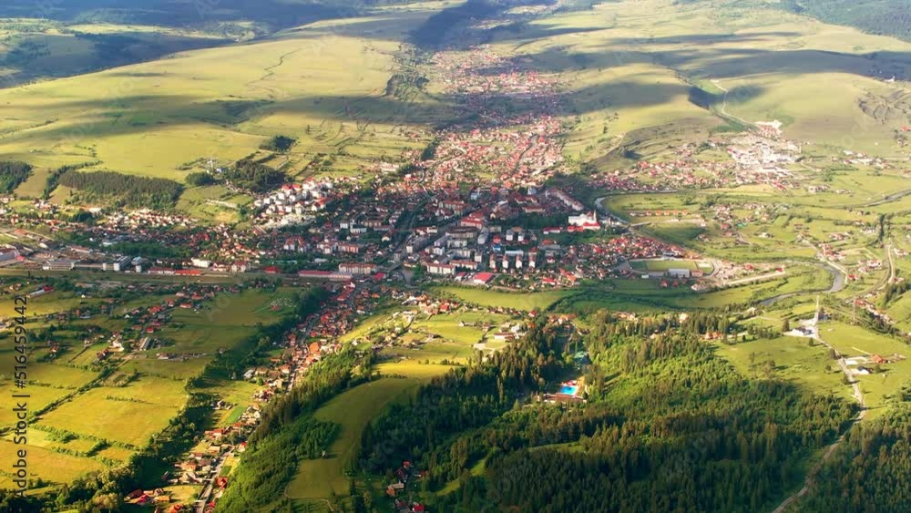 Aerial drone view of Toplita in the Carpathians in Romania. Village, fields and low hills Aerial drone view of Toplita in the Carpathians in Romania. Village, fields and low hills