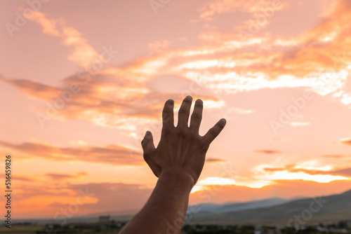 open human hand in the sunset
