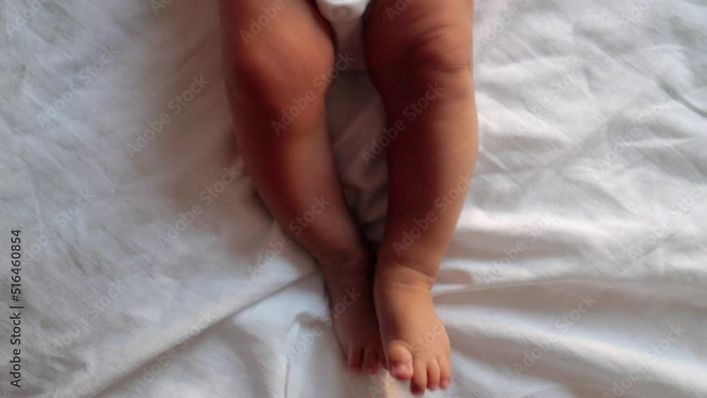 actively moving baby's legs on bed actively moving baby's legs on bed