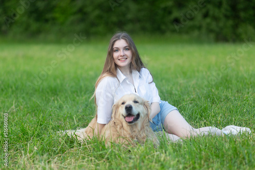 Girl with a dog, Golden Retriever. A girl with a dog in the park.