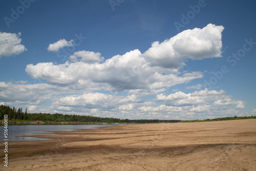 Beautiful summer landscape with clouds on the river.