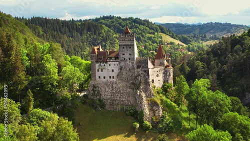 Aerial drone view of The Bran Castle in Romania. Medieval castle in Carpathians, green trees around