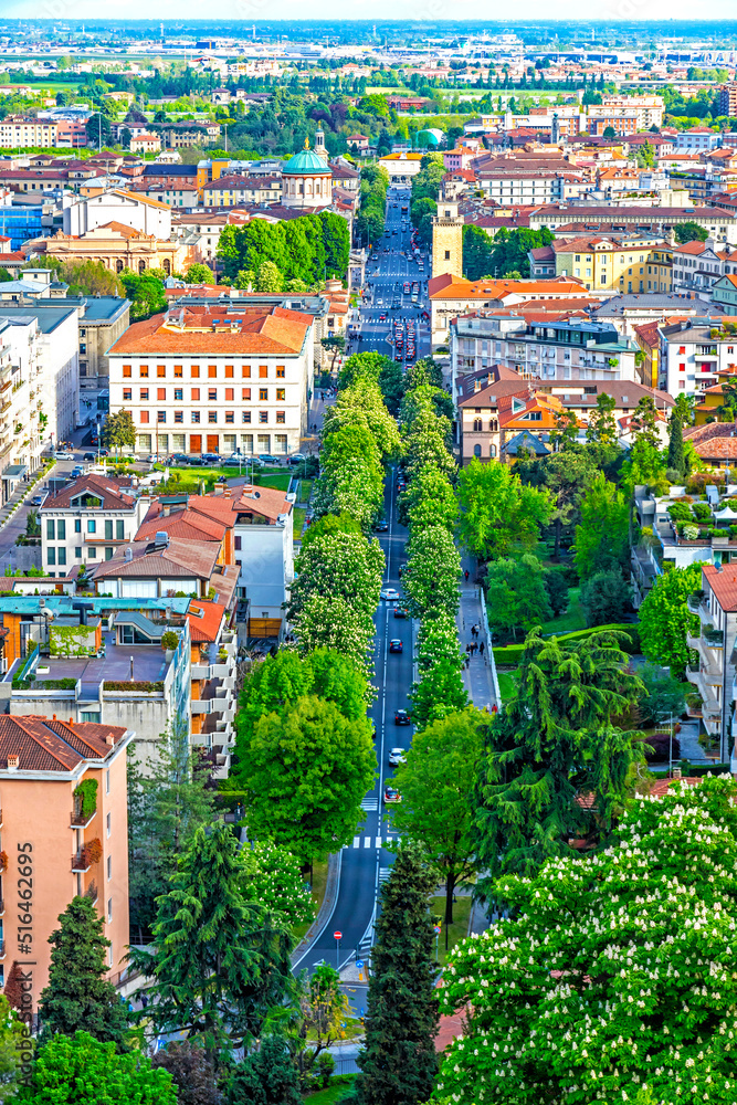 Aerial springtime panorama of Bergamo city, Lombardy province, Italy. Picturesque skyline view of Bergamo main street, Viale Vittorio Emanuele II. Bergamo railway station on background