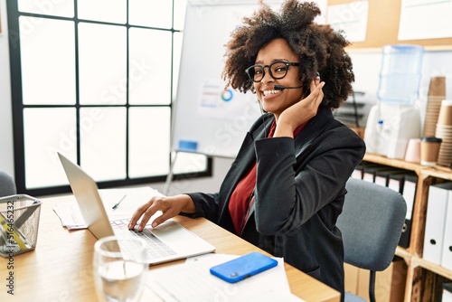 Young african american woman call center agent working at office