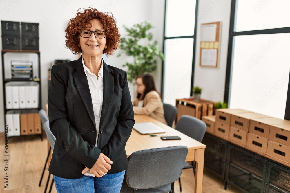 Mature woman working at inclusive teamwork. Group of two women working at the office. Mature woman working at inclusive teamwork. Group of two women working at the office.