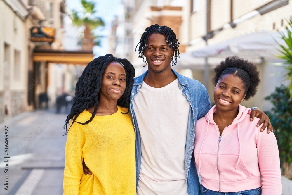 African american friends smiling confident hugging each other at street African american friends smiling confident hugging each other at street