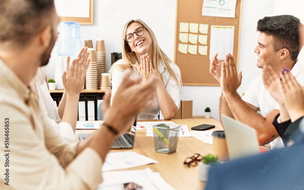 Group of young business workers smiling and clapping to partner at the office. Group of young business workers smiling and clapping to partner at the office.