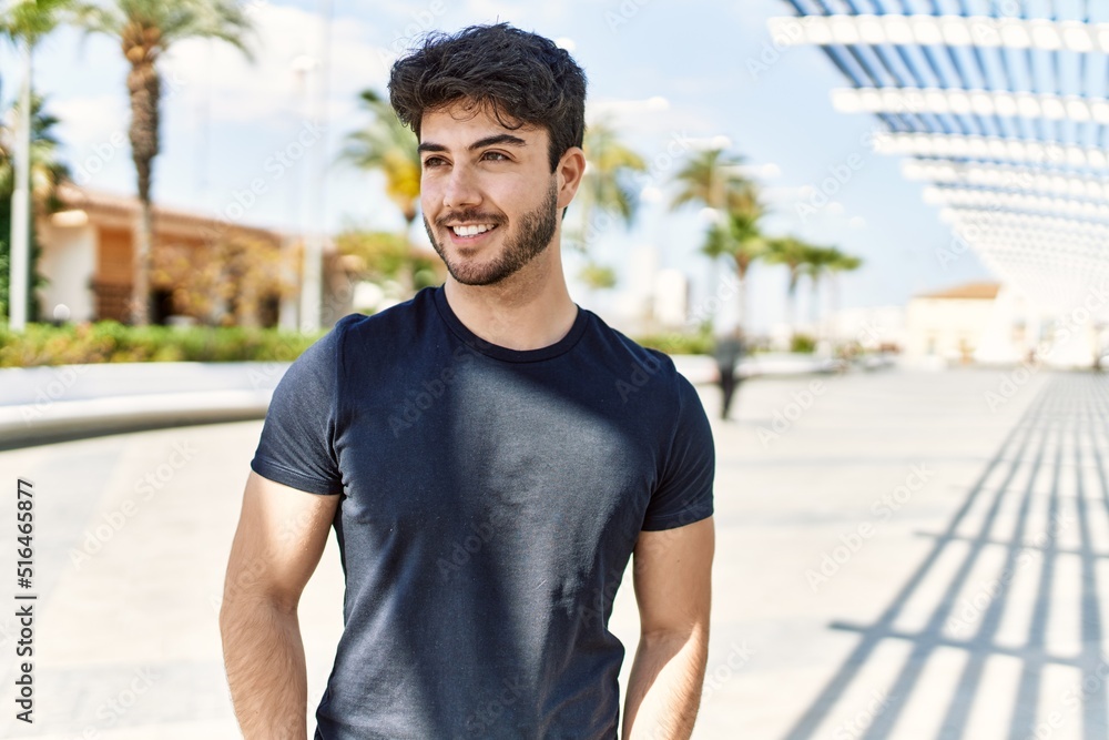 Young hispanic man smiling happy standing at the city. Young hispanic man smiling happy standing at the city.