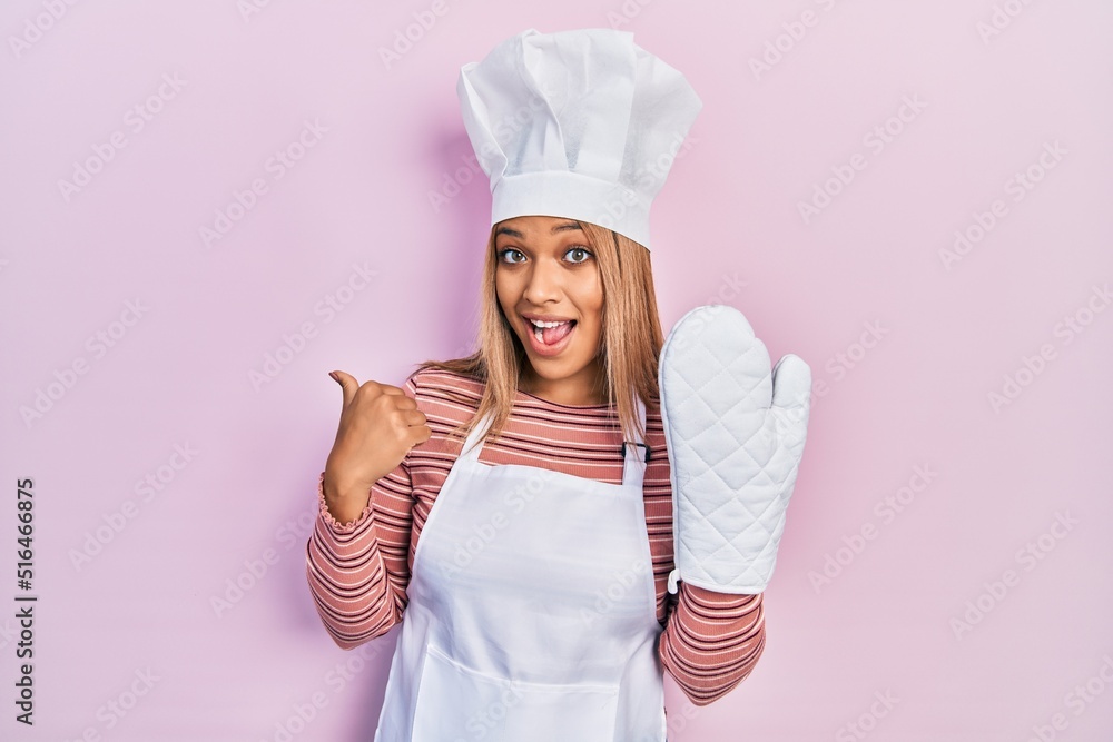 Beautiful hispanic woman uniform wearing apron and hat wearing protective glove pointing thumb up to the side smiling happy with open mouth Beautiful hispanic woman uniform wearing apron and hat wearing protective glove pointing thumb up to the side smiling happy with open mouth