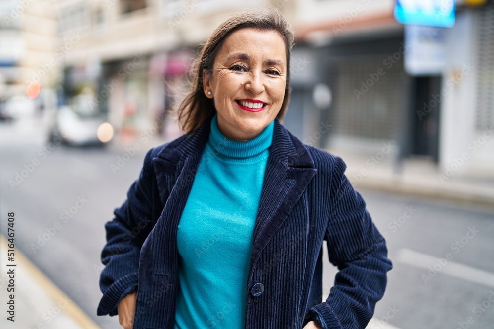 Middle age woman business executive smiling confident standing at street