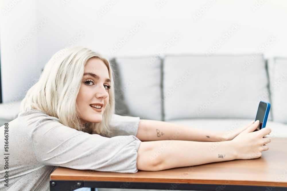 Young caucasian woman smiling confident using smartphone at home Young caucasian woman smiling confident using smartphone at home