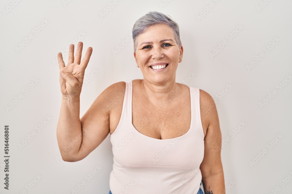 Middle age caucasian woman standing over white background showing and pointing up with fingers number four while smiling confident and happy. Middle age caucasian woman standing over white background showing and pointing up with fingers number four while smiling confident and happy.