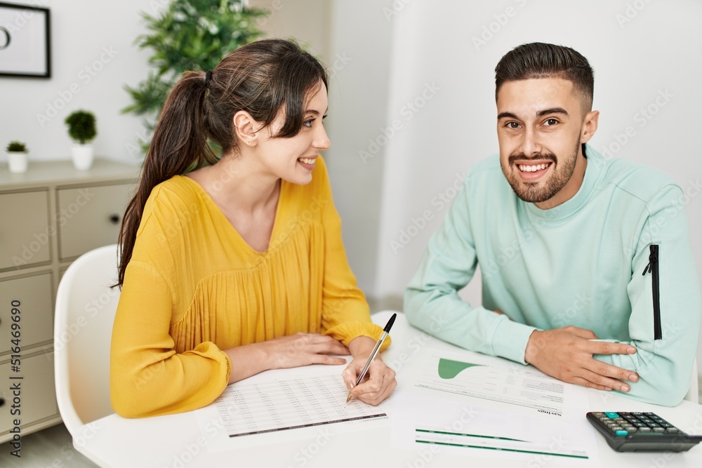 Young couple controlling family economy at home. Young couple controlling family economy at home.