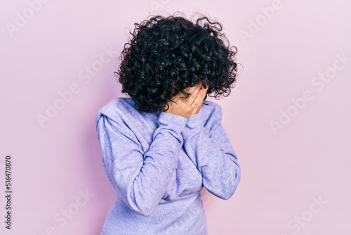 Young middle east woman wearing casual clothes with sad expression covering face with hands while crying. depression concept.