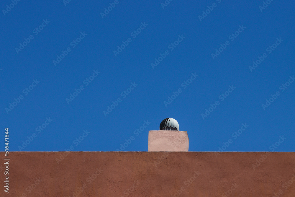 Air extractor chimney on the terrace of a building moved by the wind