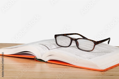 A glasses and books on a desk. World book day concept.