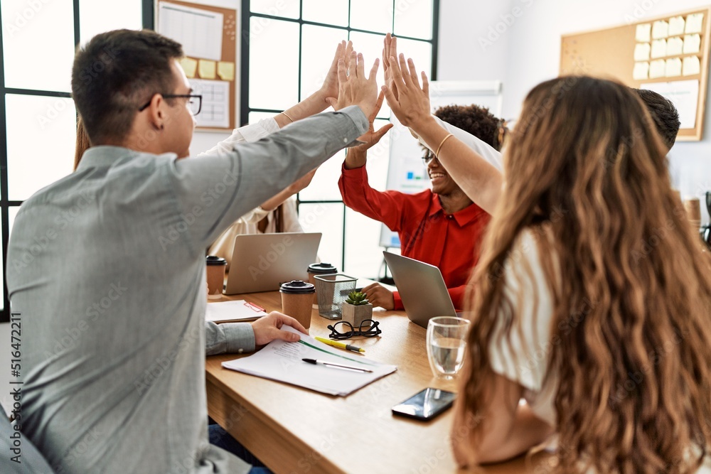 Group of business workers smiling happy celebrating with hands together at the office. Group of business workers smiling happy celebrating with hands together at the office.