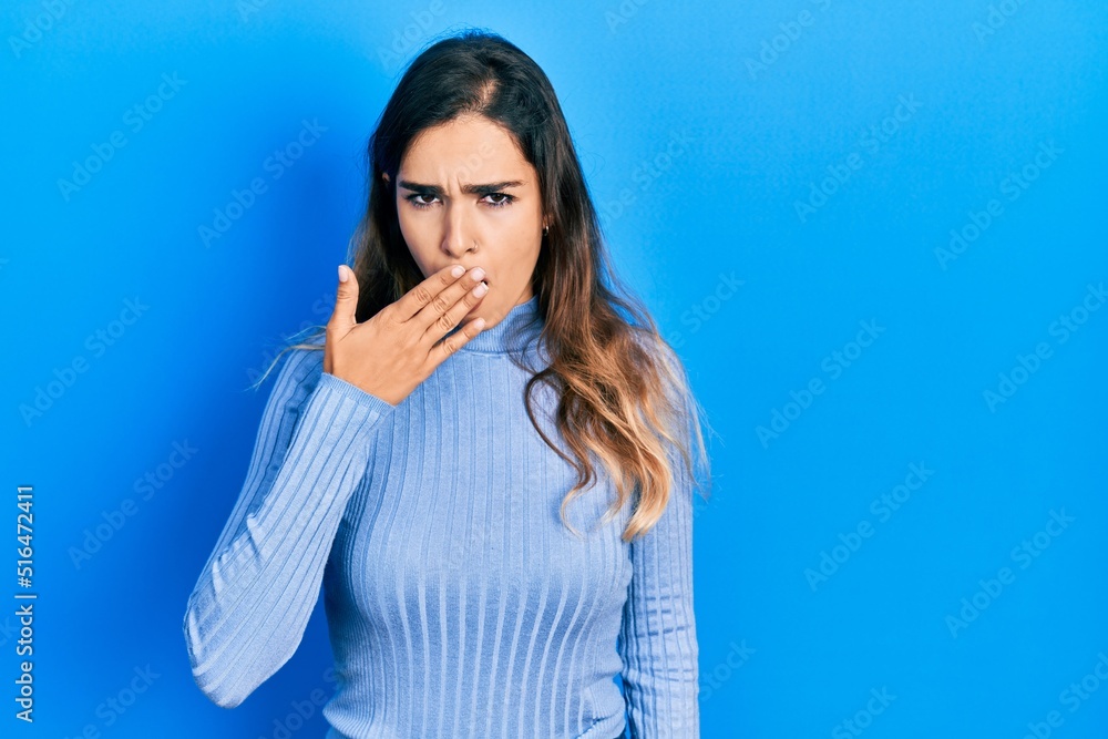 Fototapeta premium Young hispanic girl wearing casual clothes bored yawning tired covering mouth with hand. restless and sleepiness.