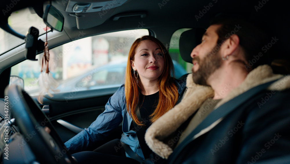 Man and woman couple smiling confident driving car at street Man and woman couple smiling confident driving car at street