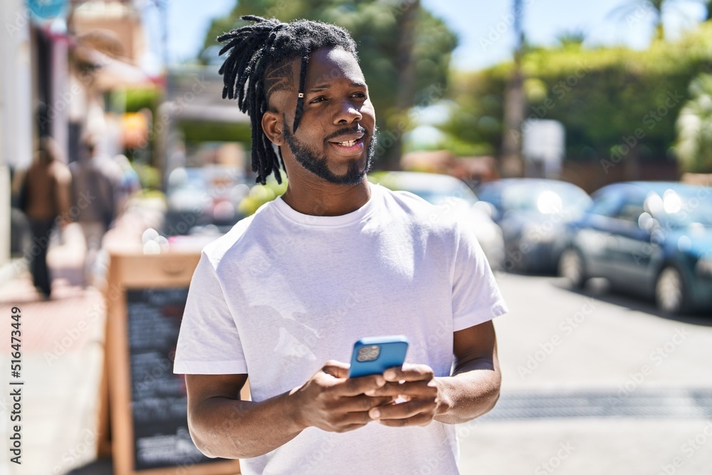 African american woman smiling confident using smartphone at street African american woman smiling confident using smartphone at street