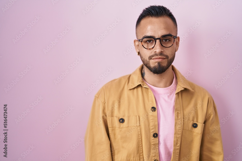 Young hispanic man standing over pink background depressed and worry for distress, crying angry and afraid. sad expression. Young hispanic man standing over pink background depressed and worry for distress, crying angry and afraid. sad expression.