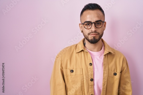 Young hispanic man standing over pink background depressed and worry for distress, crying angry and afraid. sad expression. © Krakenimages.com