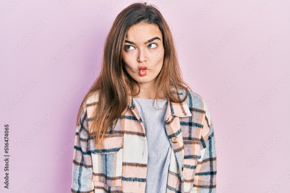 Young caucasian girl wearing casual clothes making fish face with lips, crazy and comical gesture. funny expression. Young caucasian girl wearing casual clothes making fish face with lips, crazy and comical gesture. funny expression.