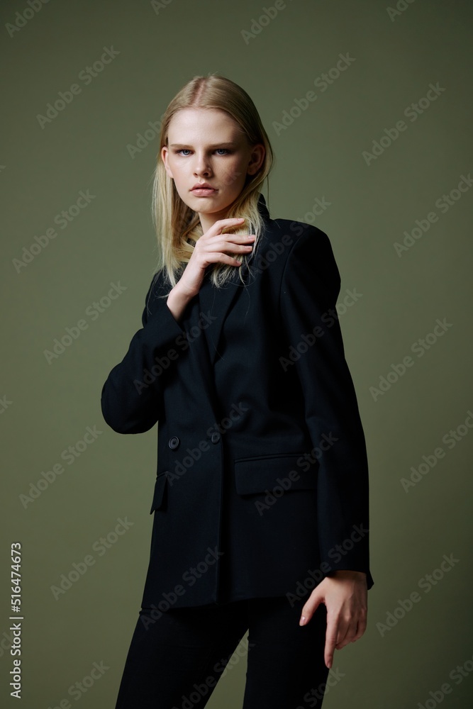 Serious self-confident young woman posing in the studio on a green background Serious self-confident young woman posing in the studio on a green background