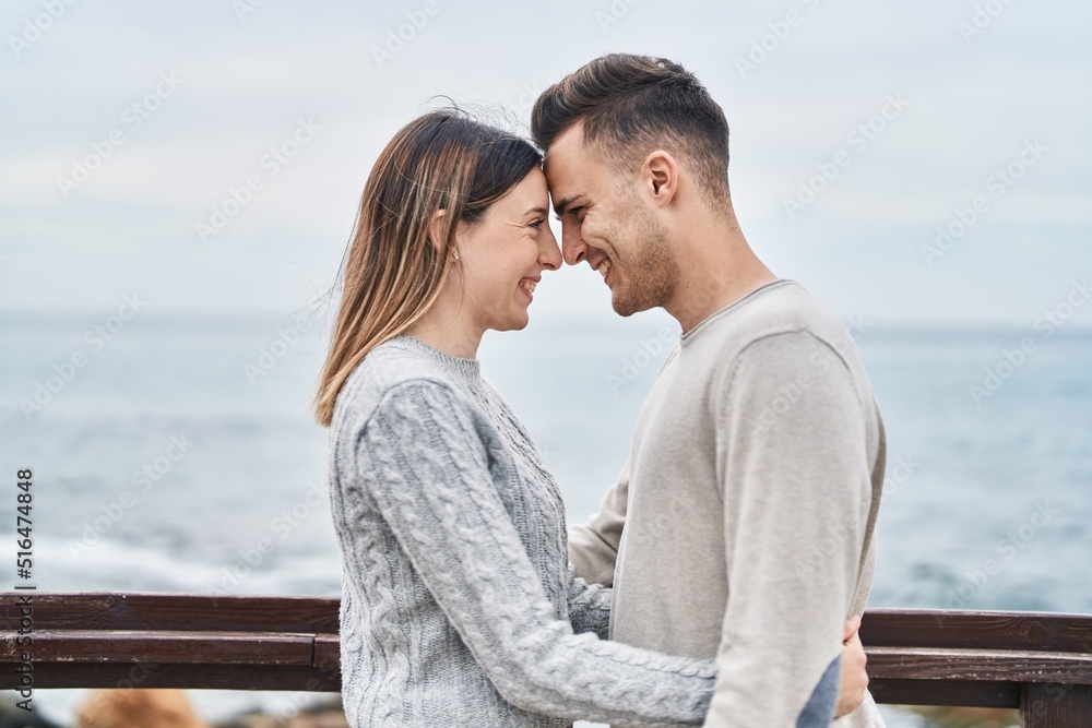 Man and woman couple smiling confident hugging each other at seaside Man and woman couple smiling confident hugging each other at seaside