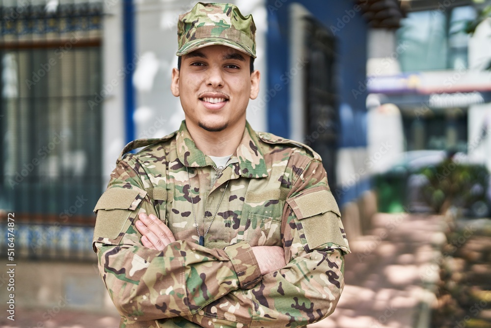 Young man army soldier standing with arms crossed gesture at street