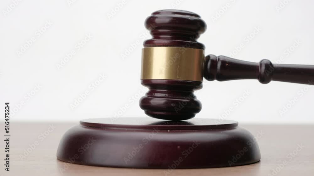 Gavel being struck to decide an auction or guilty verdict in court, Justice and law concept. Gavel being struck to decide an auction or guilty verdict in court, Justice and law concept.