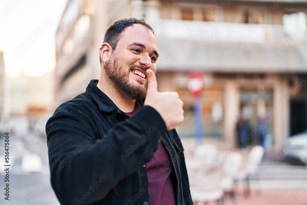 Young hispanic man smiling confident doing ok sign with thumb up at street Young hispanic man smiling confident doing ok sign with thumb up at street