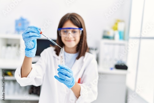 Young hispanic girl working at laboratory