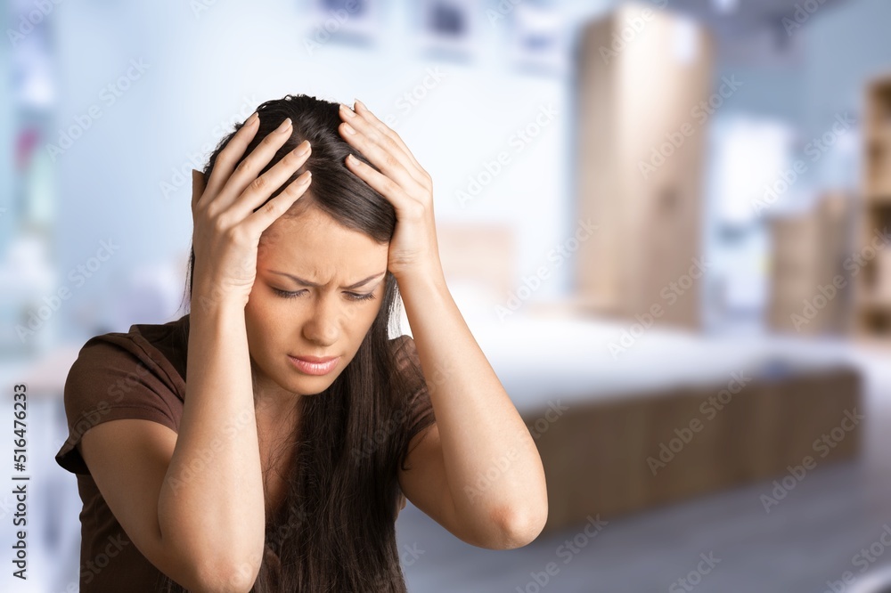Beautiful woman feeling stress and headache on sofa. She used her hand to touch her face. Office syndrome concept. Beautiful woman feeling stress and headache on sofa. She used her hand to touch her face. Office syndrome concept.