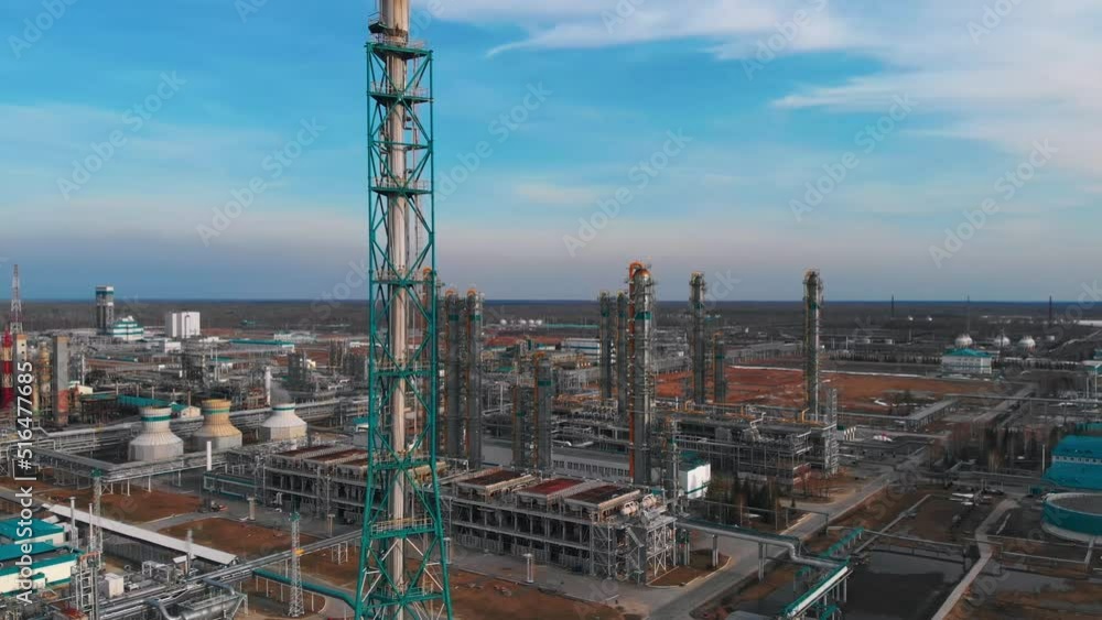 The drone flies over the flare pipeline to release excess gas. Aerial view of a large industrial complex for deep processing of oil and gas in polymers Drone view of pipelines and industrial buildings The drone flies over the flare pipeline to release excess gas. Aerial view of a large industrial complex for deep processing of oil and gas in polymers Drone view of pipelines and industrial buildings